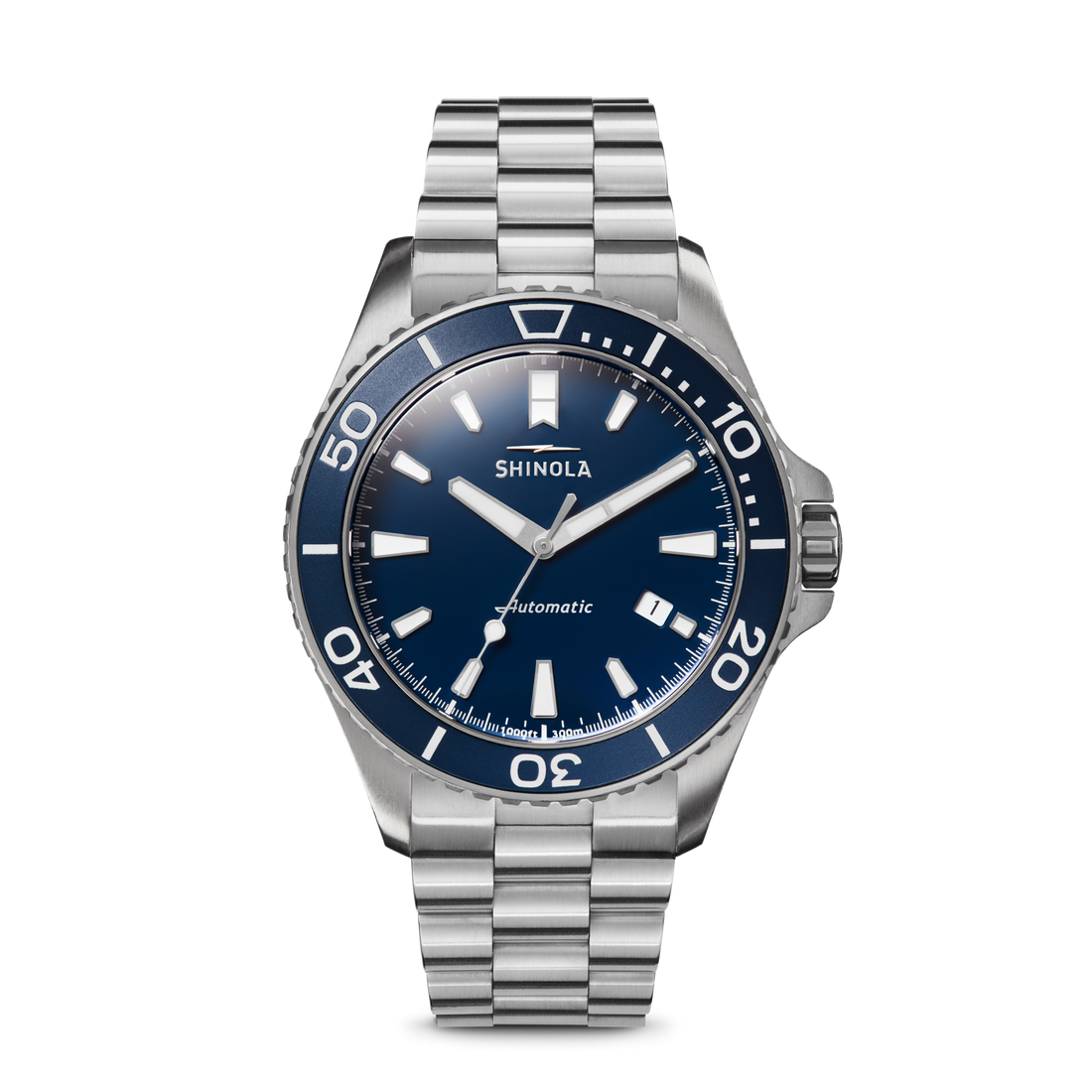 The Shinola Lake Michigan Monster Automatic Watch in Midnight Blue, featuring a silver-tone case, blue bezel and dial, silver hour markers, and a stainless steel link bracelet, is showcased against a white background.