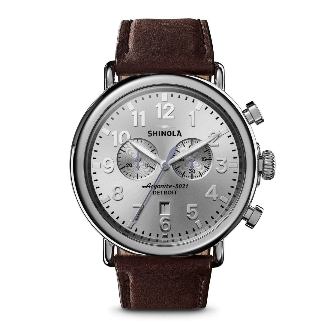The Shinola Runwell Chronograph Watch - Silver features a stainless steel case, brown leather strap, two subdials, silver hour markers, three hands, "Shinola Argonite-5021 Detroit" on the face, and two push buttons on the right side.